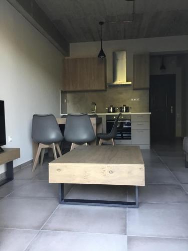 a kitchen with two chairs and a wooden table at Lagkada Suites in Kariá
