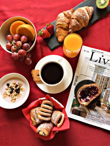 a table with breakfast foods and a cup of coffee at Hotel Senator in Gorgonzola