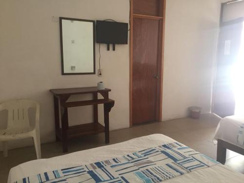 Ένα ή περισσότερα κρεβάτια σε δωμάτιο στο Hotel Carruiz