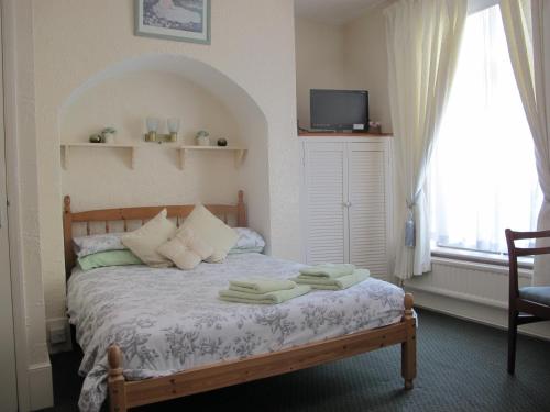 A bed or beds in a room at St Martins Guest House