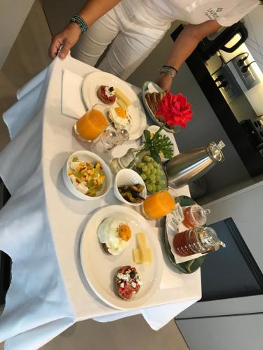 a table with plates of breakfast food on it at Lavris City Suites in Heraklio Town