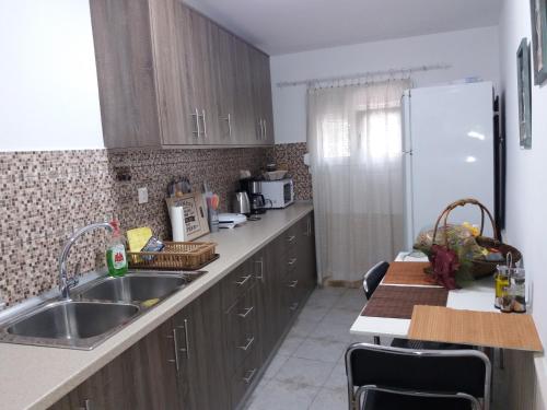 a kitchen with a sink and a refrigerator at Polianthi Seaside House in Marathos