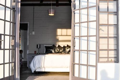 a bedroom with a bed with white sheets and pillows at Avonsrus Guesthouse in Augrabies
