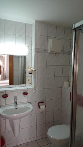 a bathroom with a sink and a toilet at Hotel 3 Linden in Leipzig