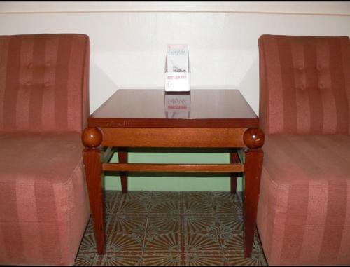 a table with a box on it next to two chairs at Hôtel Du Brabant in Paris