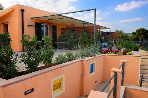 a house with a garden on top of a wall at Poggio dei Gorleri in Diano Marina