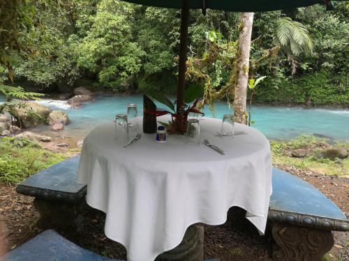 a table with a white table cloth on top of it at Cabinas Piuri in Rio Celeste