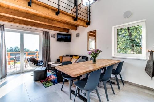 a dining room with a wooden table and chairs at Chata na sjezdovce in Malenovice