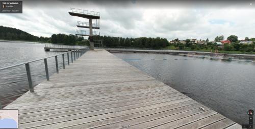 a wooden dock next to a body of water at Česlovos sodyba in Zarasai