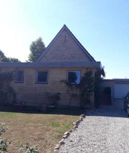 a brick house with a driveway in front of it at Rosenhuset in Haderslev