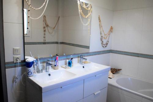 a bathroom with a sink and a mirror and a tub at Lousoan in Aix-en-Provence