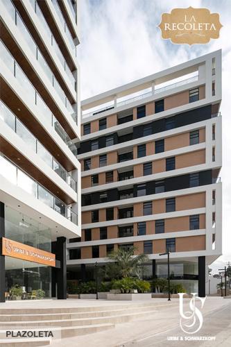 a tall building with a sign in front of it at ItsaHome Selection - Torre La Recoleta in Quito