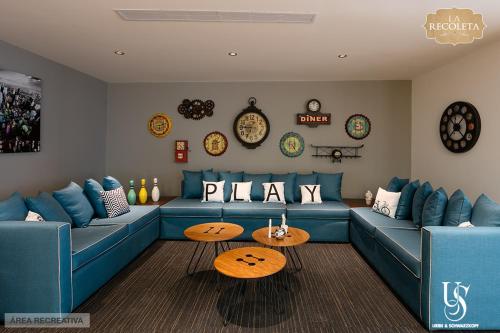 a living room with a blue couch and a table at ItsaHome Selection - Torre La Recoleta in Quito