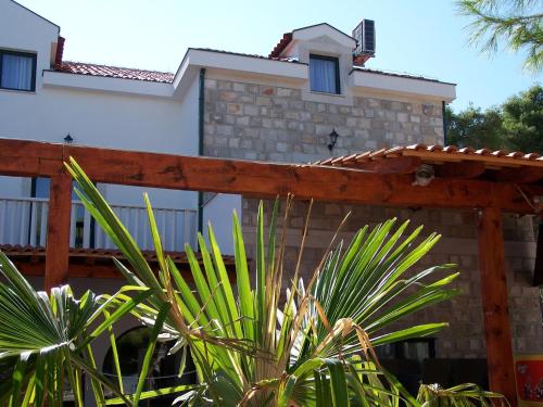 a house with a wooden fence in front of it at Hotel Sveti Kriz in Trogir