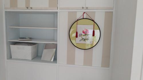 a mirror hanging on a wall with a shelf at EMS Enoshima クラシックゲストハウス 寝室は個室 犬OK in Fujisawa