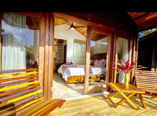 a room with a bedroom with a bed and a balcony at Marbucks Bed & Breakfast in San Pedro