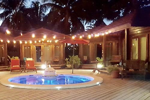 a house with a swimming pool in the middle of a patio at Marbucks Bed & Breakfast in San Pedro