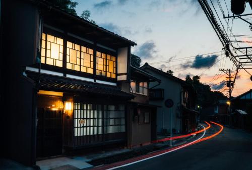 a building on a street with lights on at Tenjin TABI-NE in Kanazawa