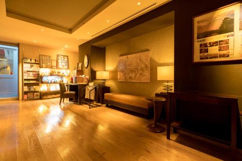 a living room with a couch and a table at Matsumoto Marunouchi Hotel in Matsumoto