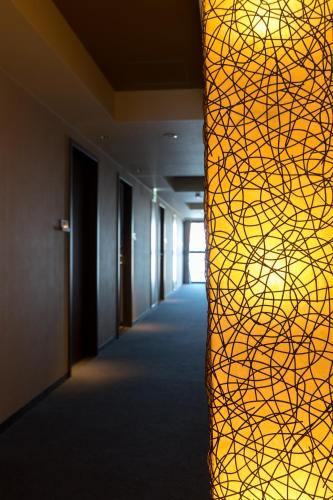 a hallway of an office with a yellow wall at Matsumoto Marunouchi Hotel in Matsumoto