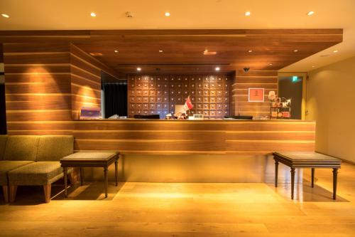 a bar in a restaurant with two tables and benches at Matsumoto Marunouchi Hotel in Matsumoto
