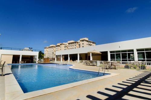 a swimming pool in front of a building at Apartamento Ilhéus - Vog Sul in Ilhéus