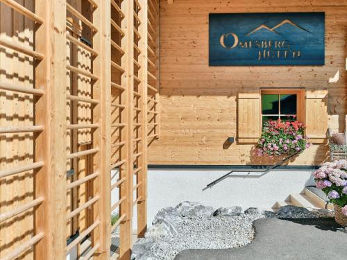 a building with a sign on the side of it at Omesberg-Hütt'n in Lech am Arlberg