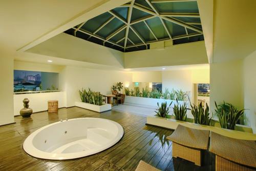 a large living room with a large tub in the middle of the room at Grand Hotel Preanger in Bandung