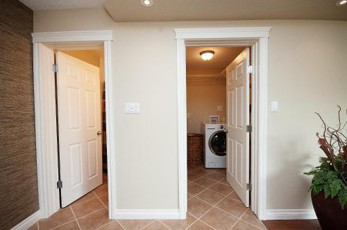 un pasillo con una puerta que conduce a una lavandería en McKinnon Pointe #307, en Edmonton