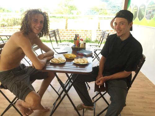 a man and a woman sitting at a table with food at Sunshine Homestay in Phong Nha
