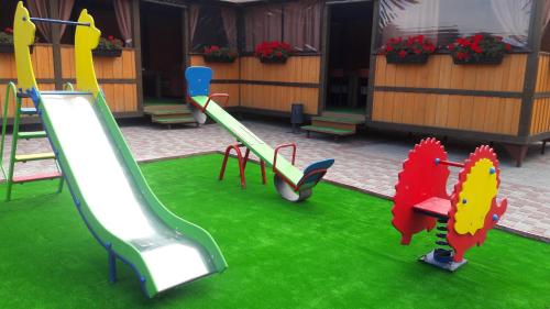 a playground with a slide at Globus Hotel in Ternopilʼ
