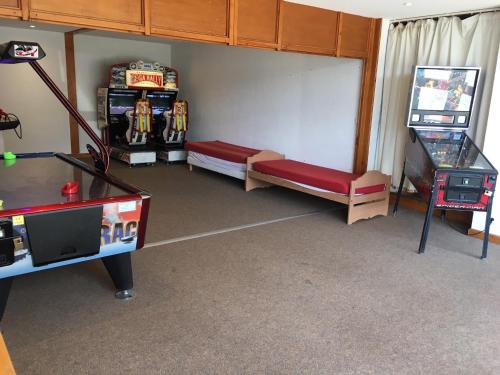 a room with a video game room with a ping pong table at T3 Les deux Alpes Vallée Blanche in Les Deux Alpes