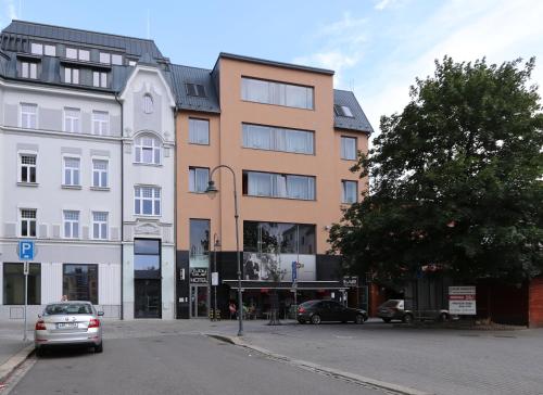 a building on a street with cars parked in front of it at Ruby Blue in Ostrava