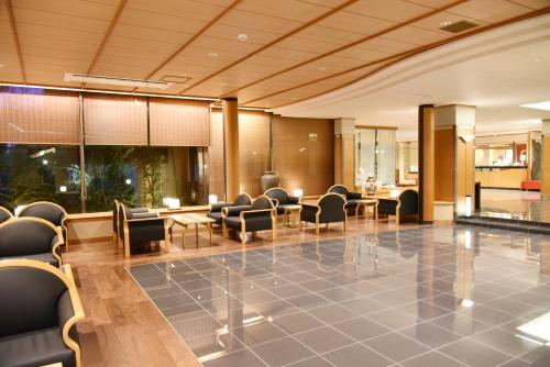 a lobby with chairs and tables in a building at Arima Onsen Taketoritei Maruyama in Kobe