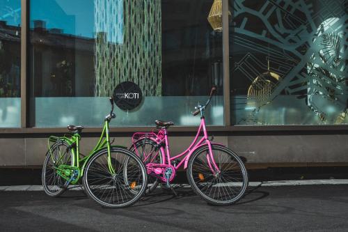 three bikes parked in front of a building at Hostel Café Koti in Rovaniemi