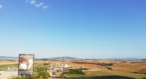 a billboard in the middle of a field with a city at MADI' casa vacanze in Laiatico