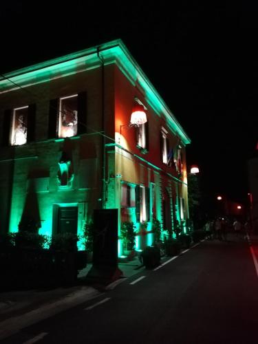 a building with green and red lights on it at MADI' casa vacanze in Laiatico