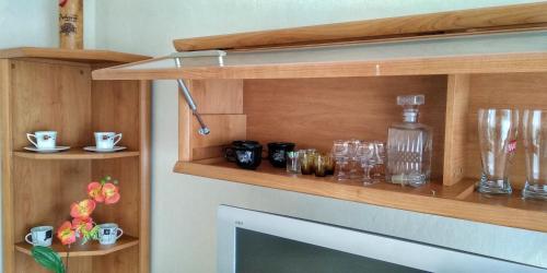 a shelf above a fireplace with glasses on it at Domek nad morzem Wisełka in Wisełka