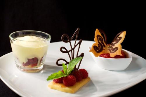 a plate with two desserts and a glass of milk at APIPURA hotel rinner in Soprabolzano
