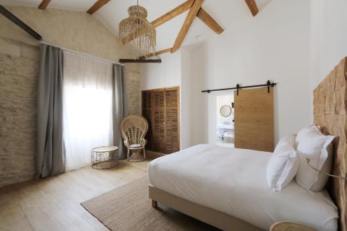 a hotel room with a bed and a dresser at Le Saint Remy in Saint-Rémy-de-Provence