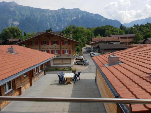 a view from a balcony of a town with mountains at Swiss Chalet Holidays Ringgenberg in Ringgenberg