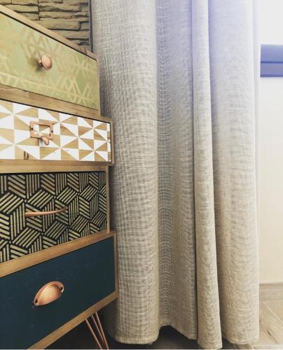 a curtain in a room with a table and a drawer at Isolabella in Mazara del Vallo