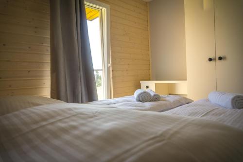 a bedroom with two beds with towels on them at Jaśminowy Sad in Mikołajki