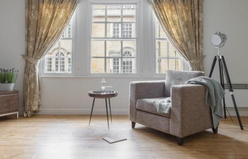 a living room filled with furniture and a window at SACO Bath - St James Parade in Bath