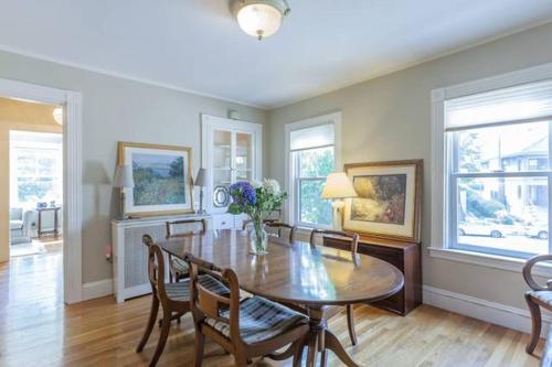 a dining room with a table and some chairs at Charming Harvard Victorian in Cambridge