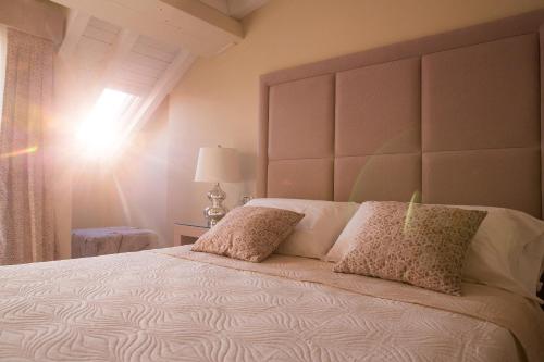 a bedroom with a large bed with a large headboard at Attico in Canicattì