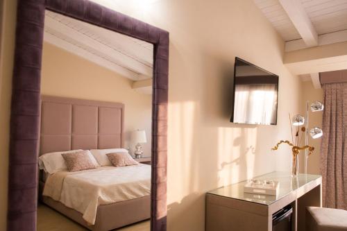 a bedroom with a large mirror and a bed at Attico in Canicattì