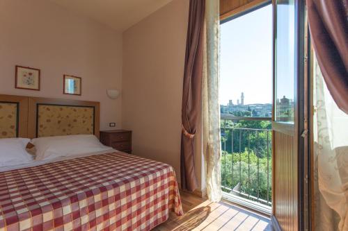 Un pat sau paturi într-o cameră la Hotel Il Giardino