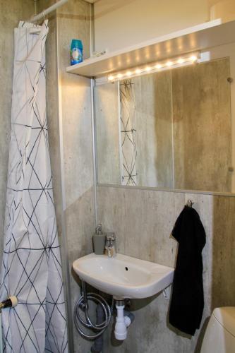 a bathroom with a sink and a mirror at Nordic Inn Thorshavn in Tórshavn