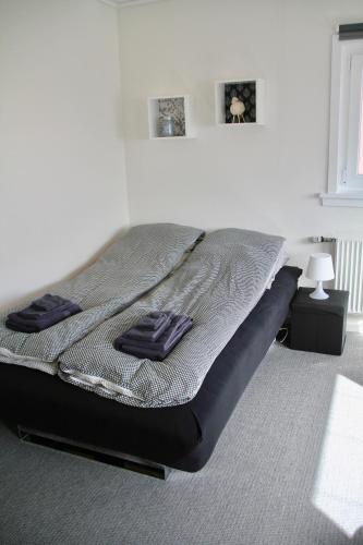 a bed in a bedroom with two towels on it at Nordic Inn Thorshavn in Tórshavn
